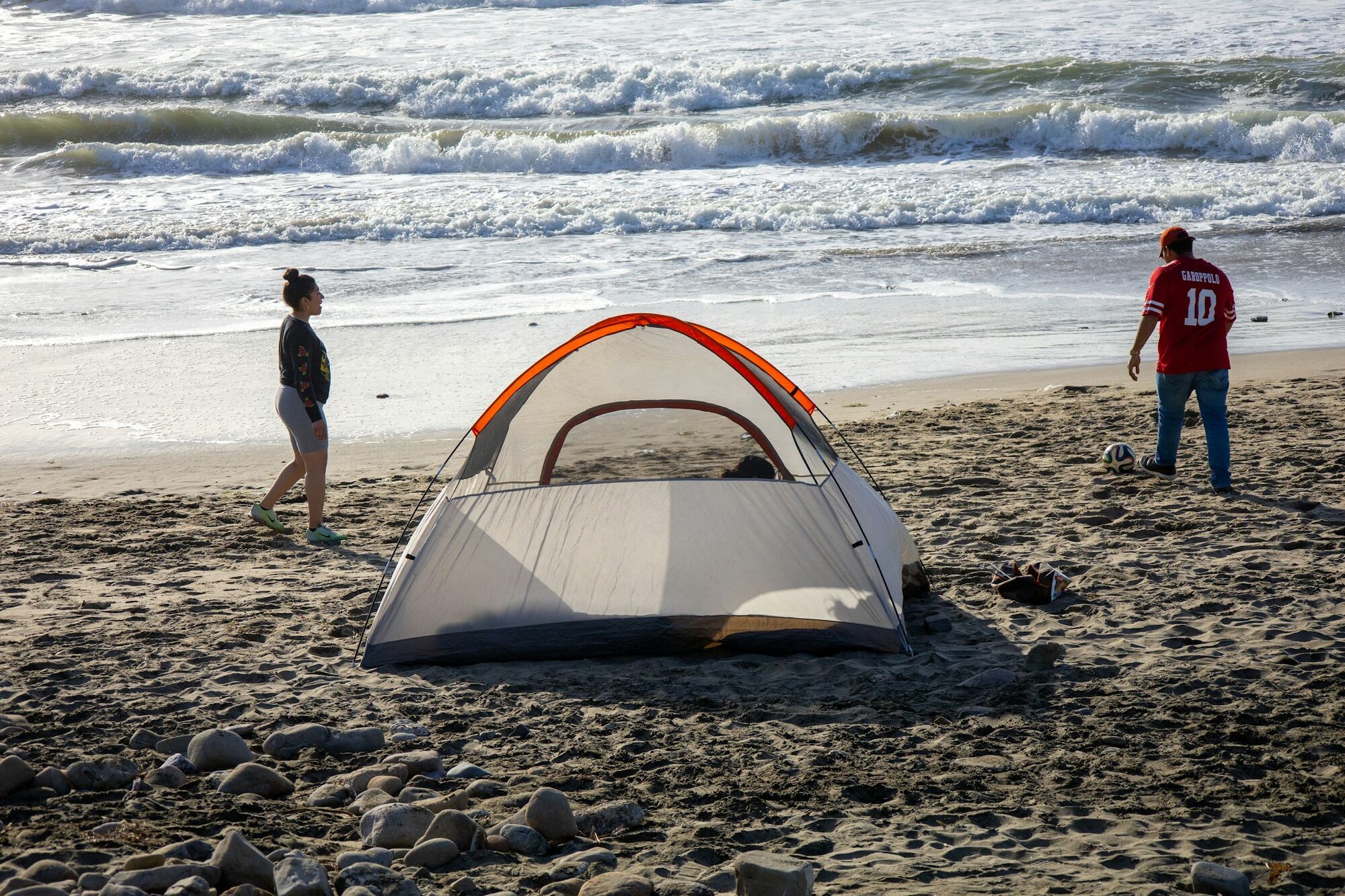 Tent and football set up on a sandy beach