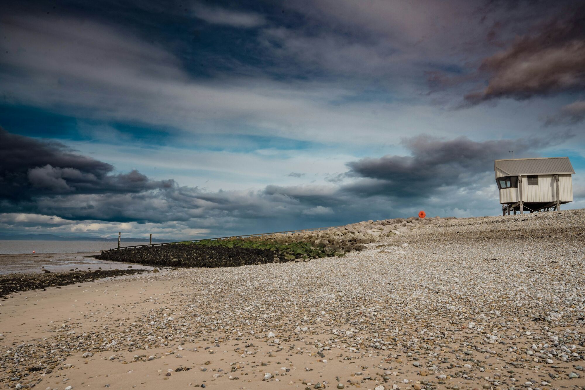 Rocky Morecambe Bay shoreline under storm clouds