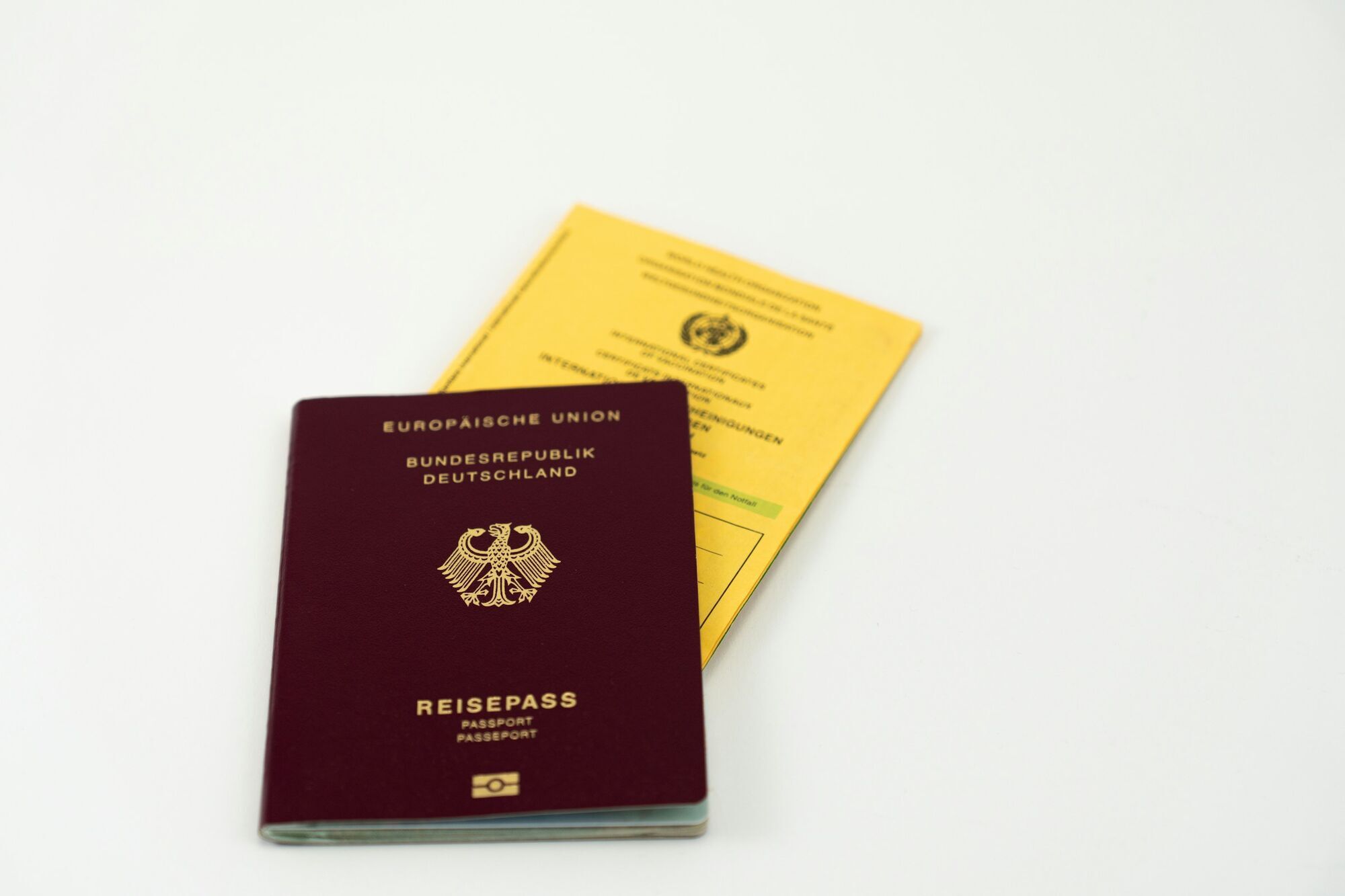 German passport beside an international vaccination certificate