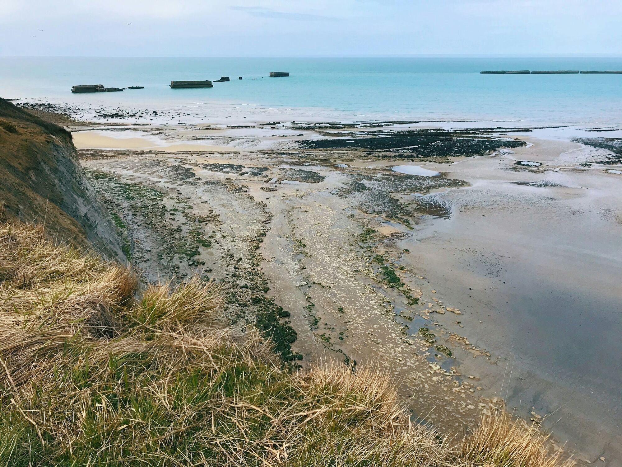 Normandy coast with D-Day remains offshore