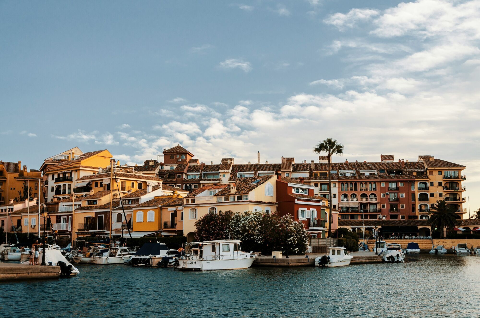 Boats beside colourful waterfront homes in Spain