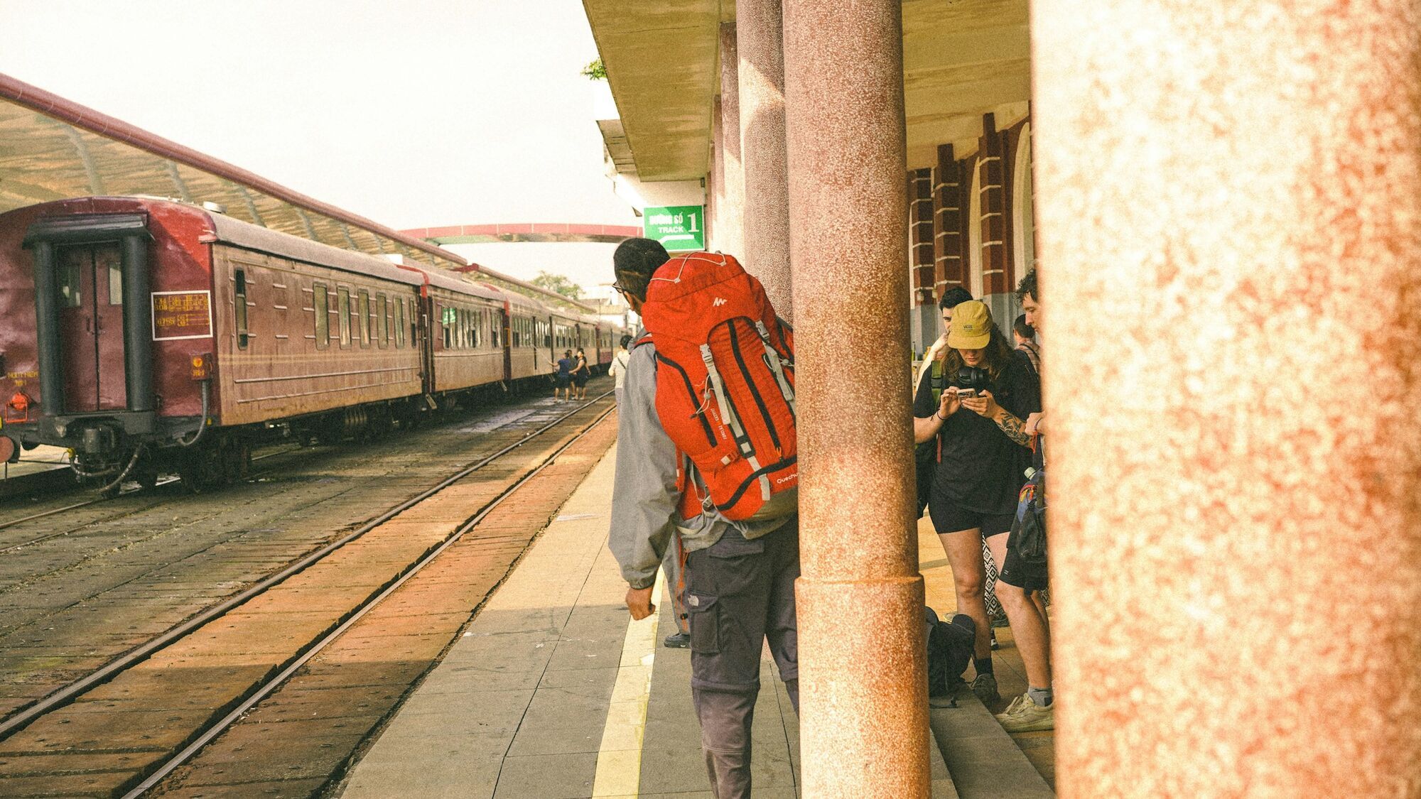 Travellers waiting beside a train platform