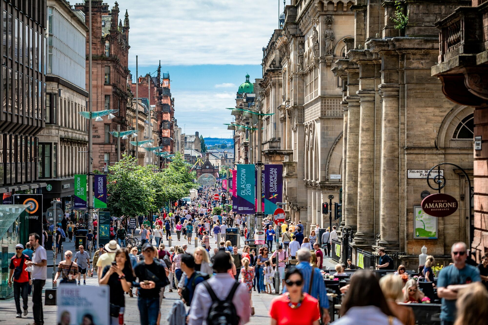 Crowds walking along a Glasgow city street
