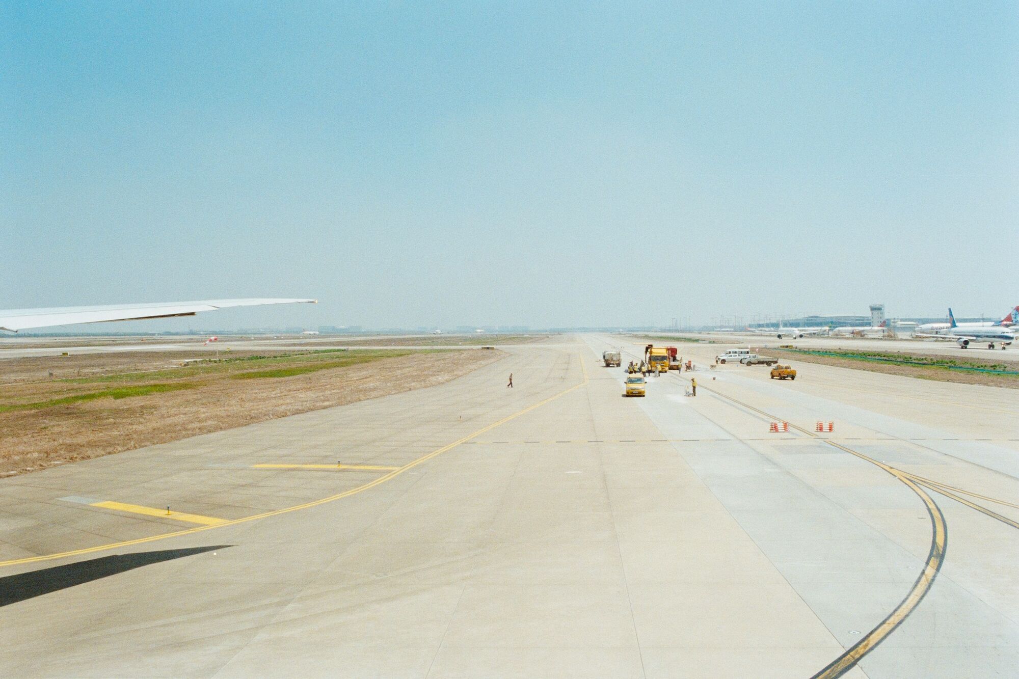 Airport taxiway with maintenance vehicles