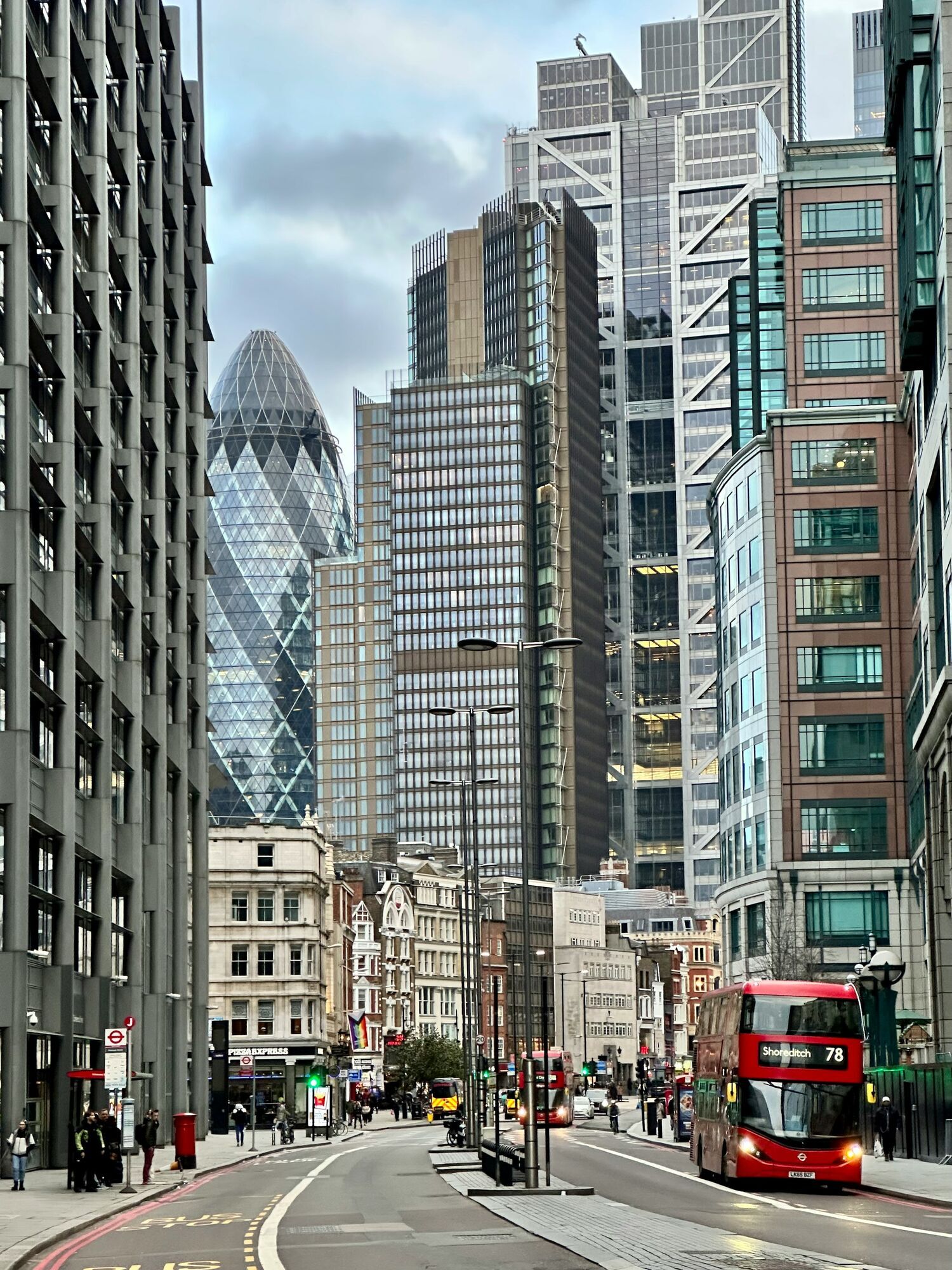 London street with red buses and city towers