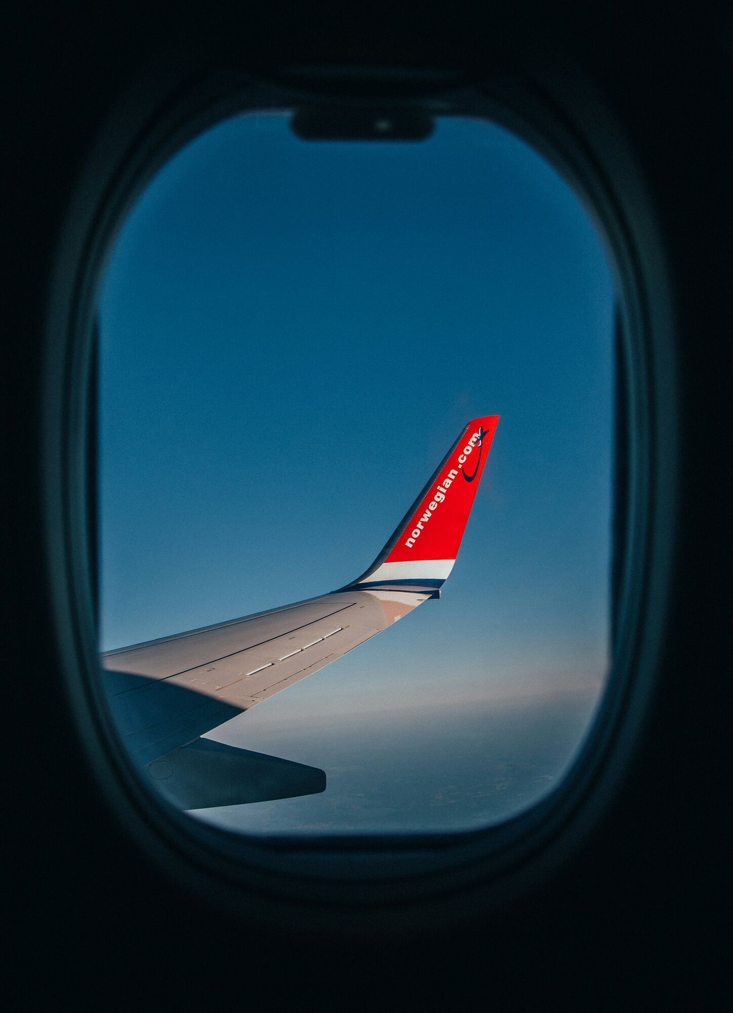 Norwegian aircraft wing seen from cabin window