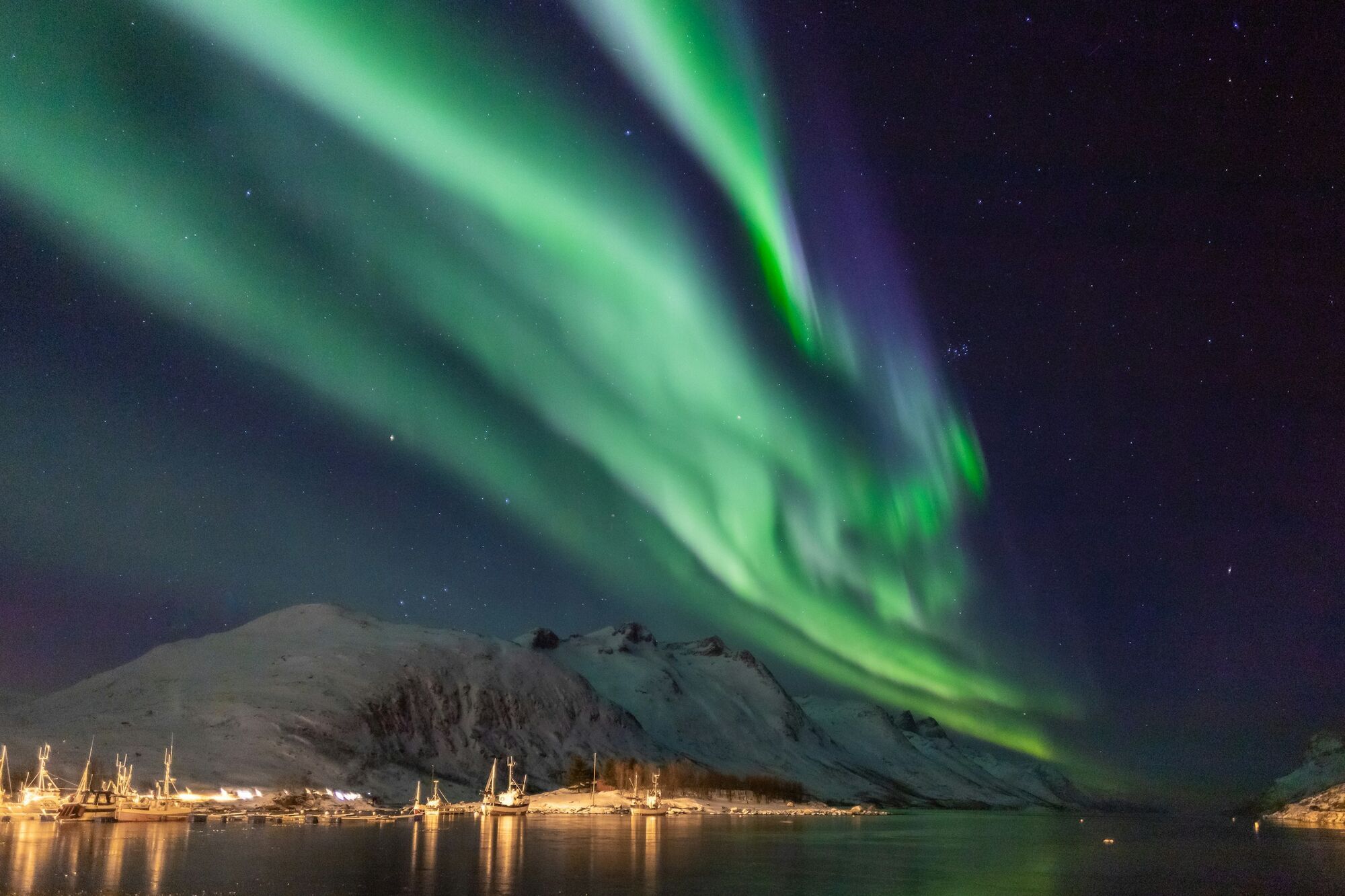 Northern Lights over snowy Tromsø mountains