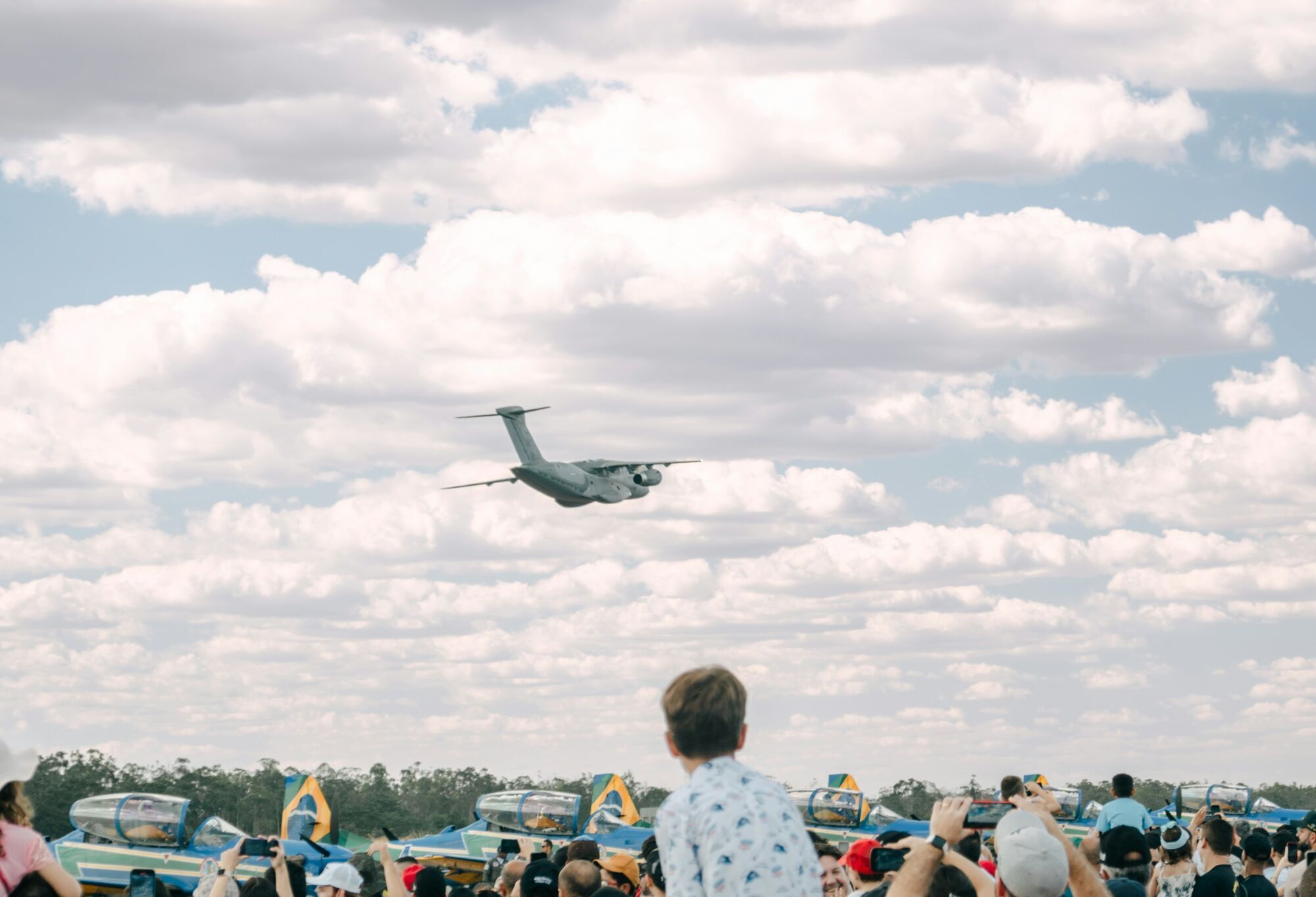 Crowd watching an aircraft fly overhead