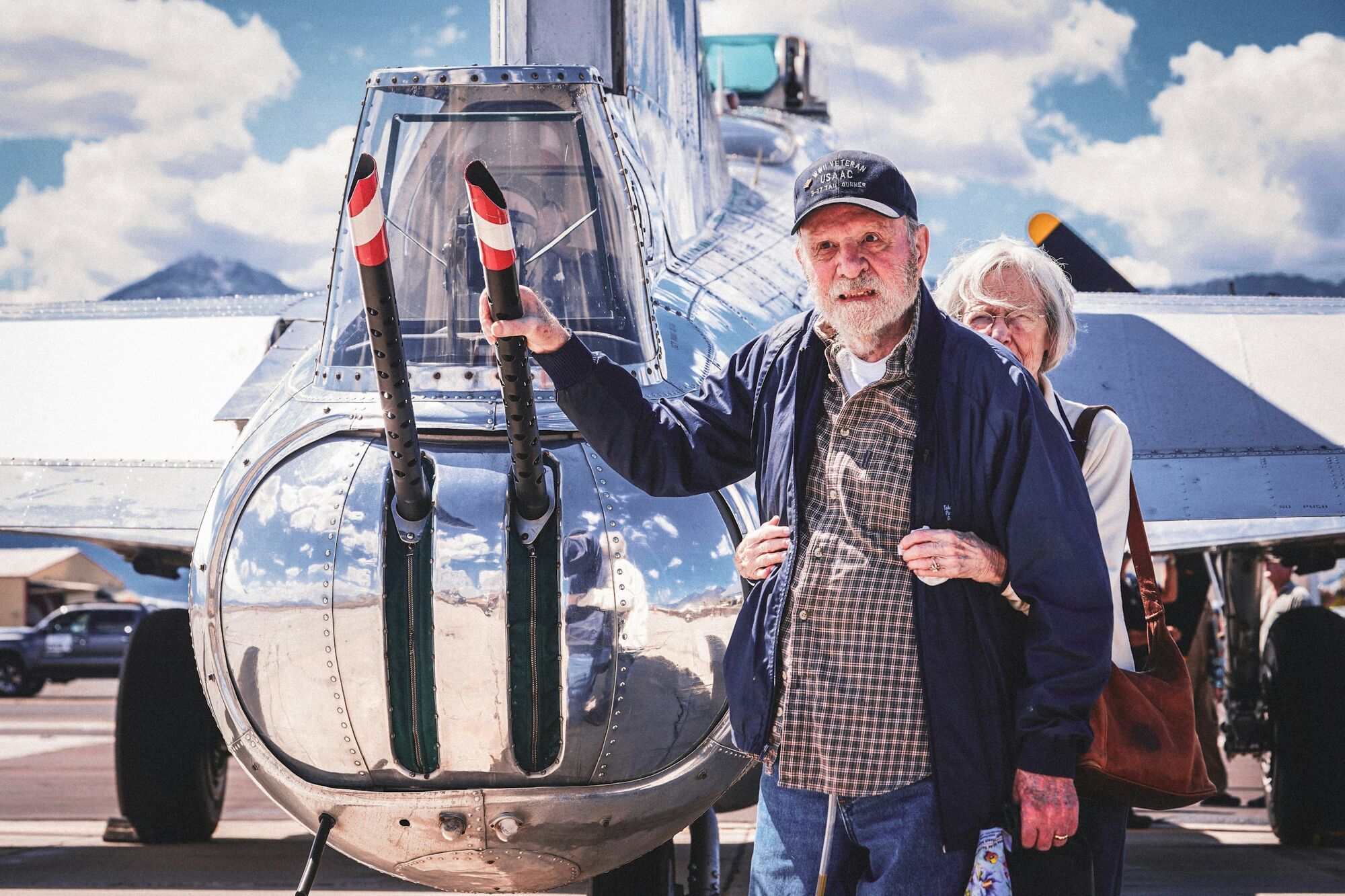 Older couple standing beside an aircraft