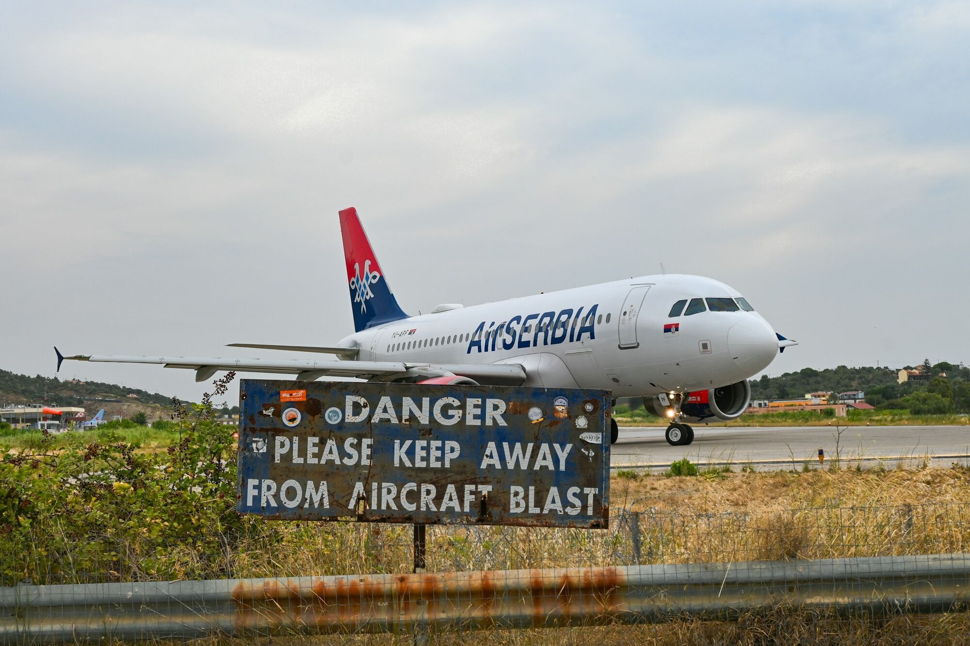 Aircraft beside a jet blast warning sign
