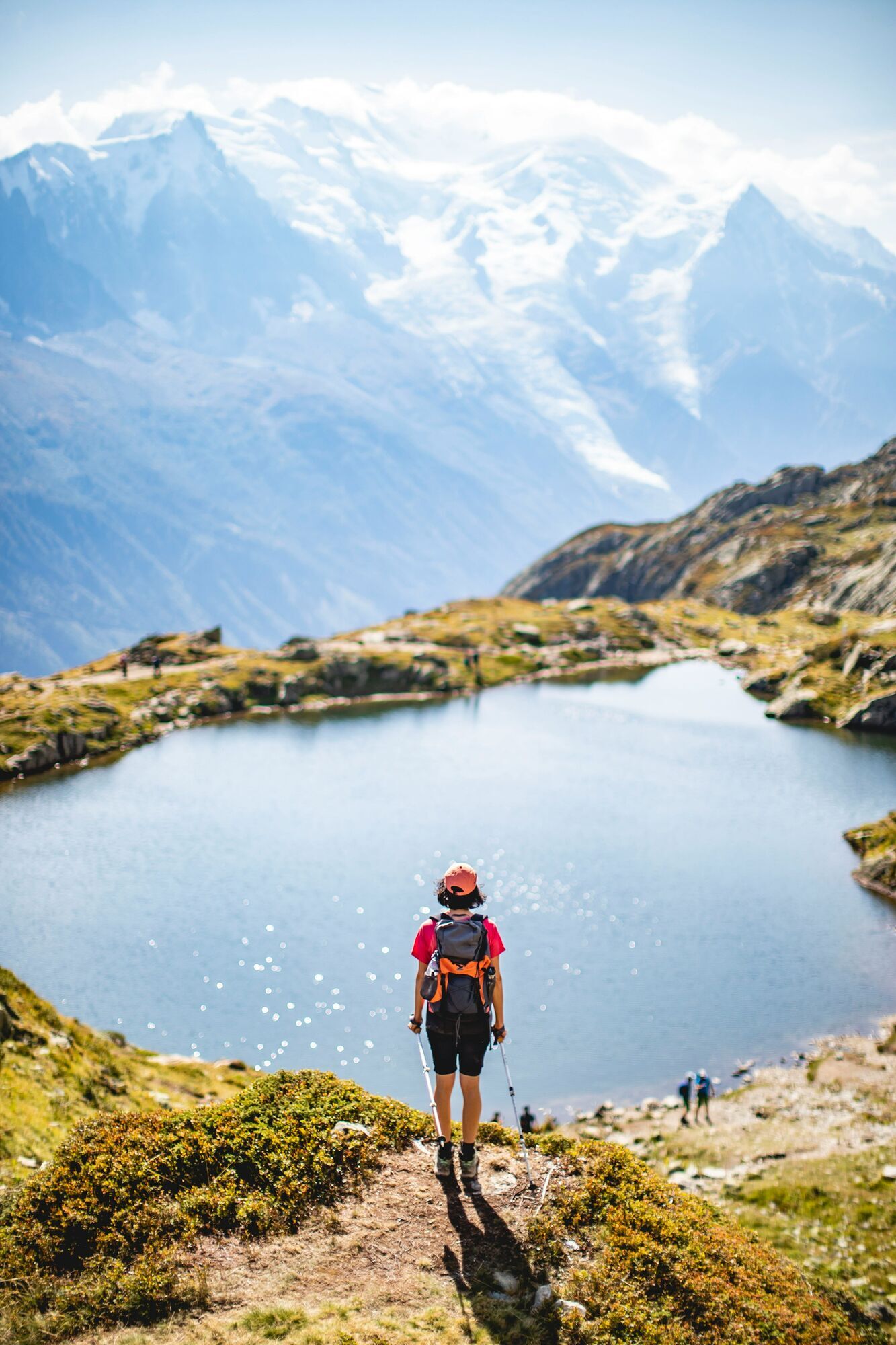 Hiker overlooking an Alpine lake near Mont Blanc