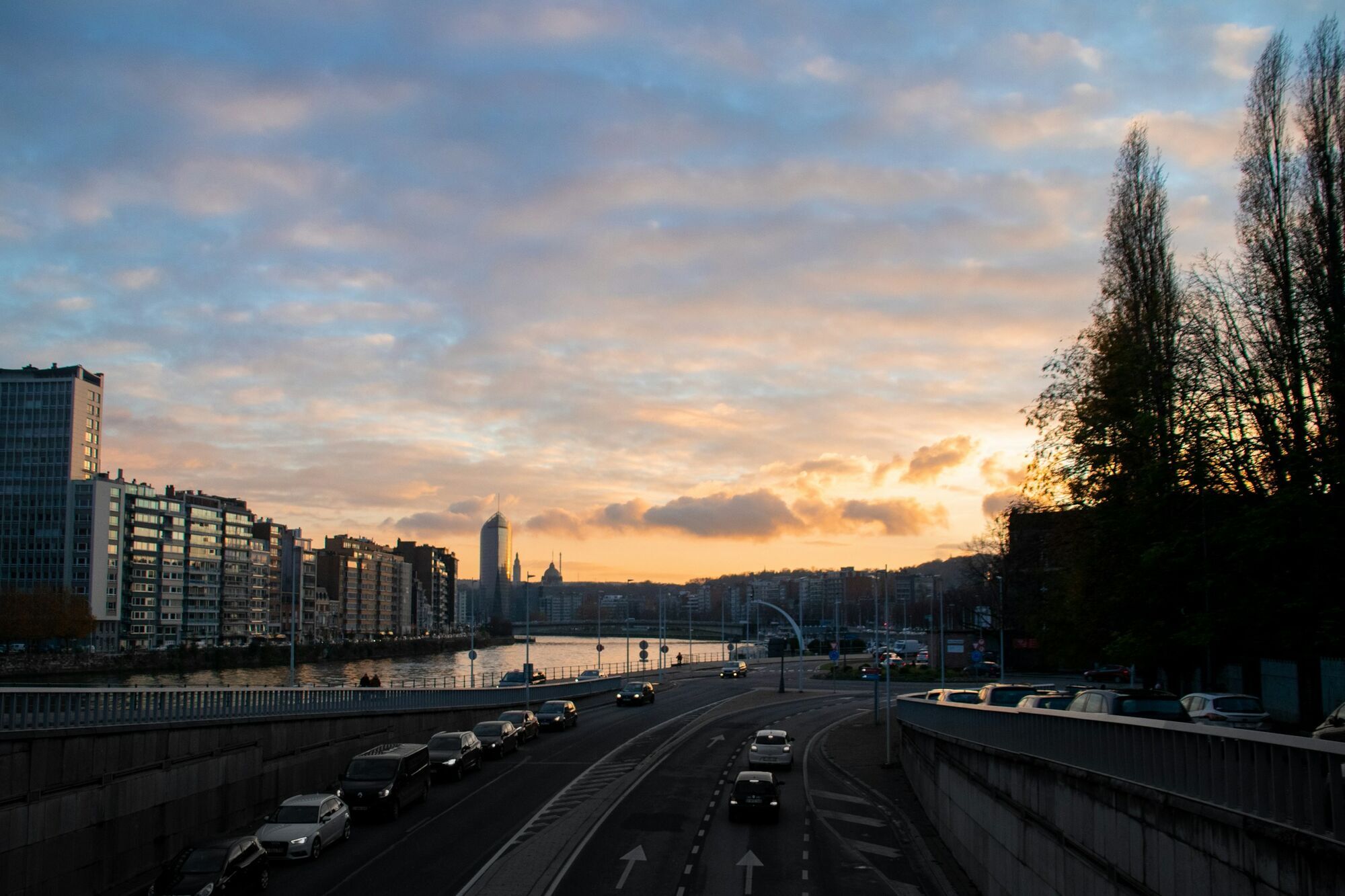 Road and river through Liège at sunset