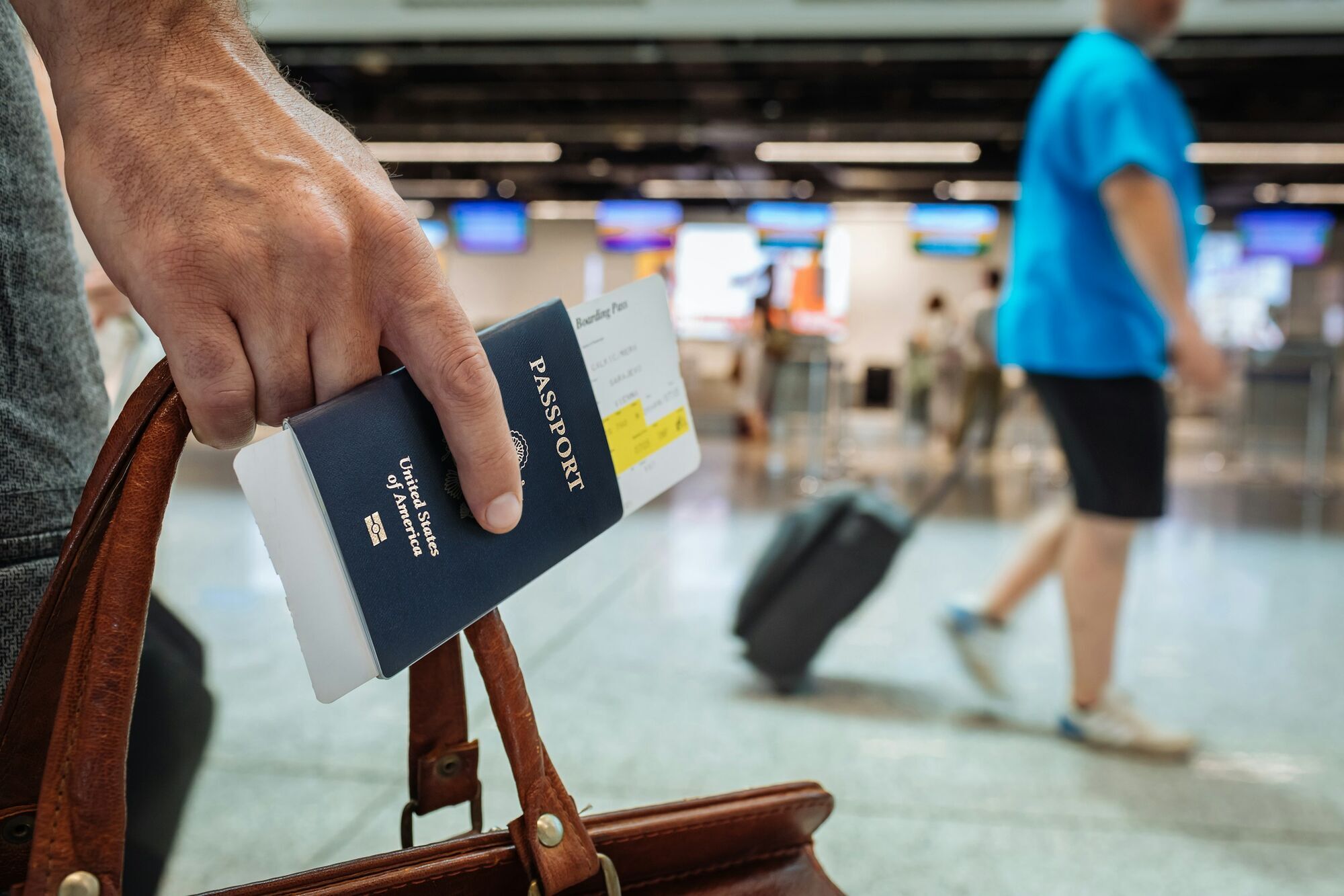 Traveller holding a passport and boarding pass