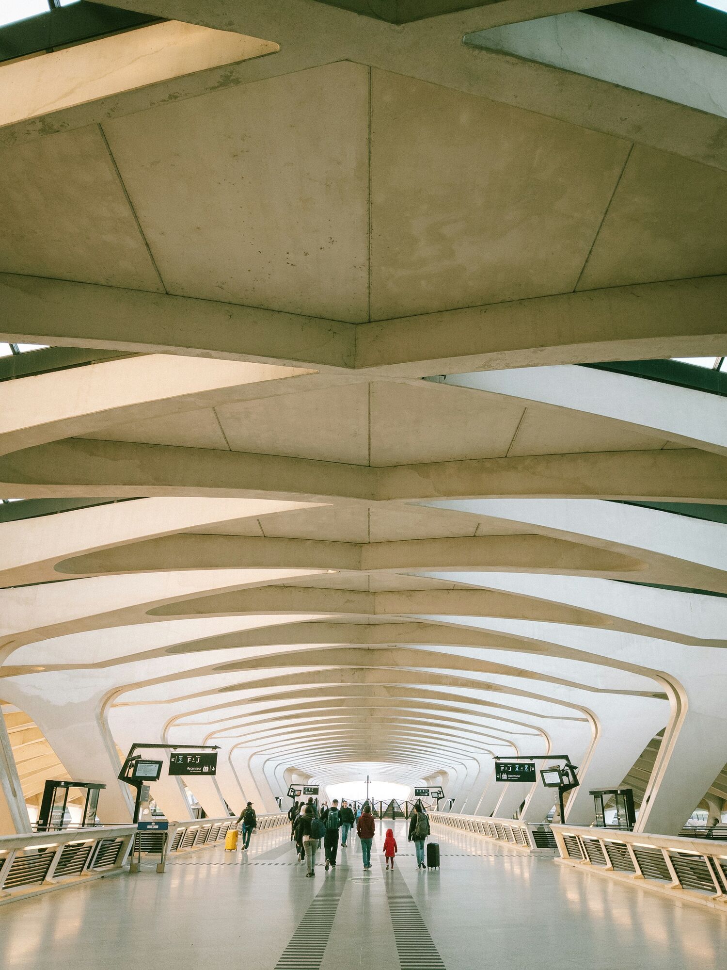 Travellers walking through modern airport terminal