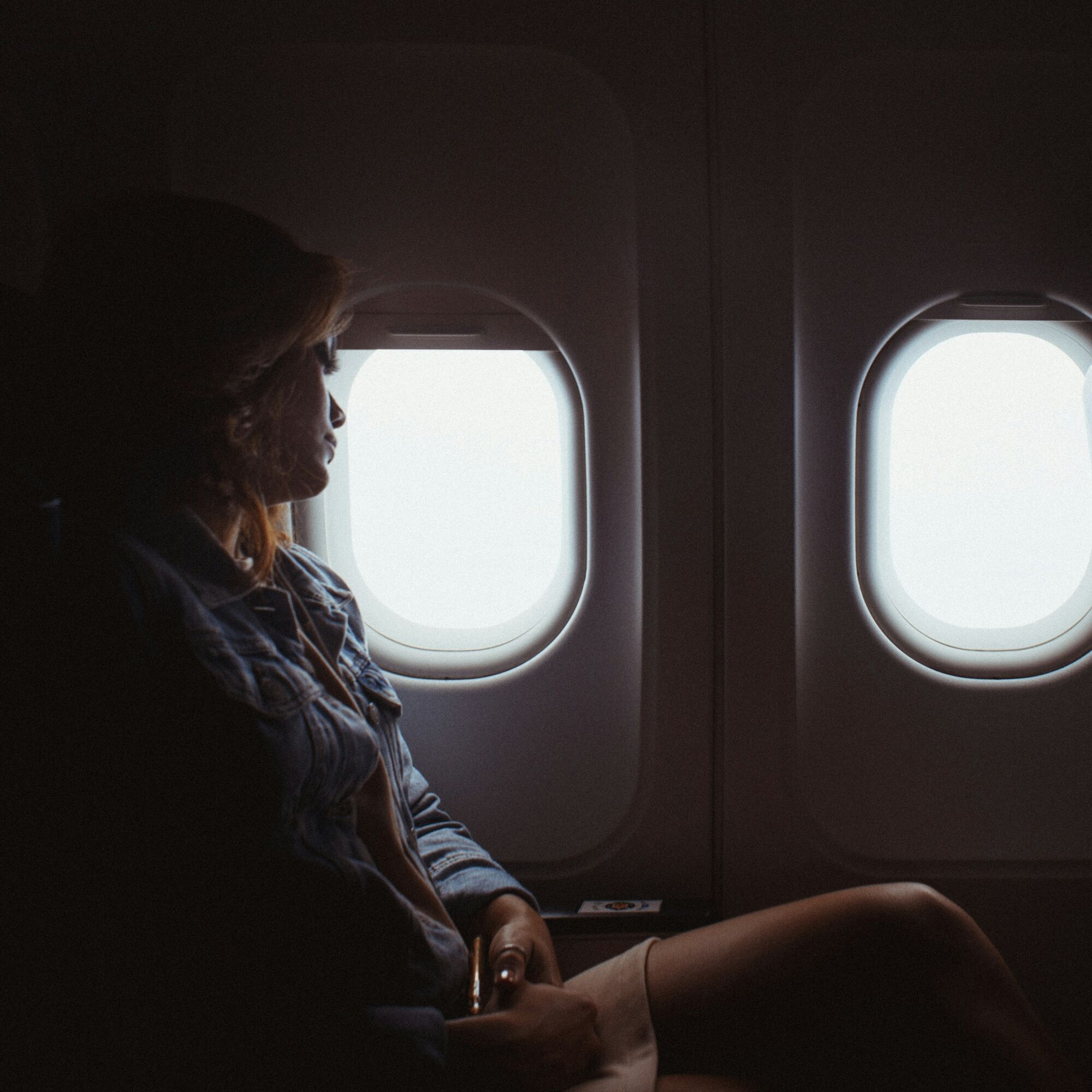 Woman seated by an aircraft window