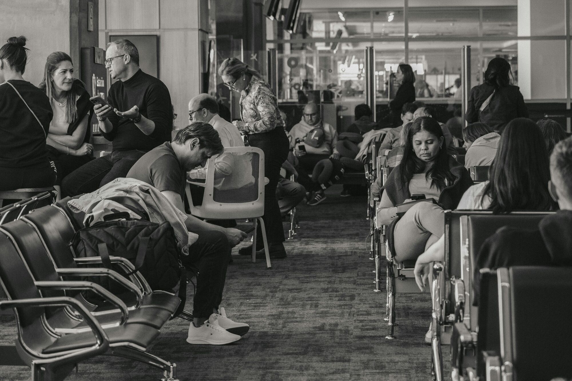 Passengers waiting in a crowded airport departure lounge