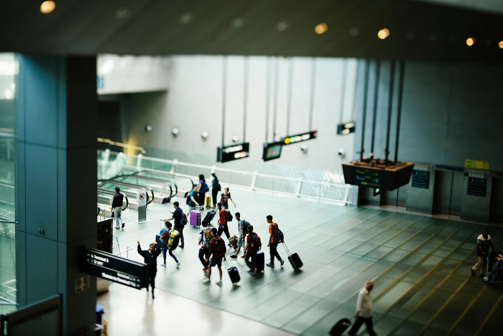 Travellers walking through an airport terminal