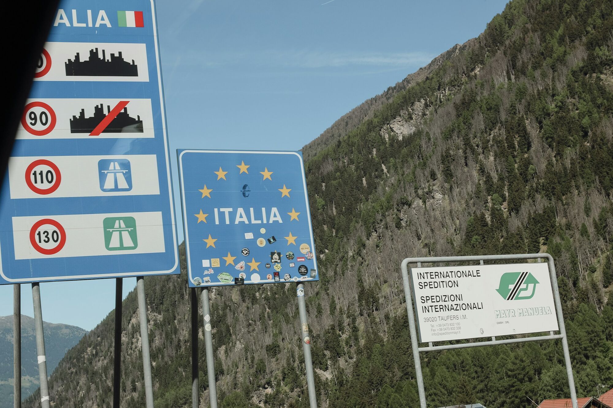 Italy border sign on a mountain road