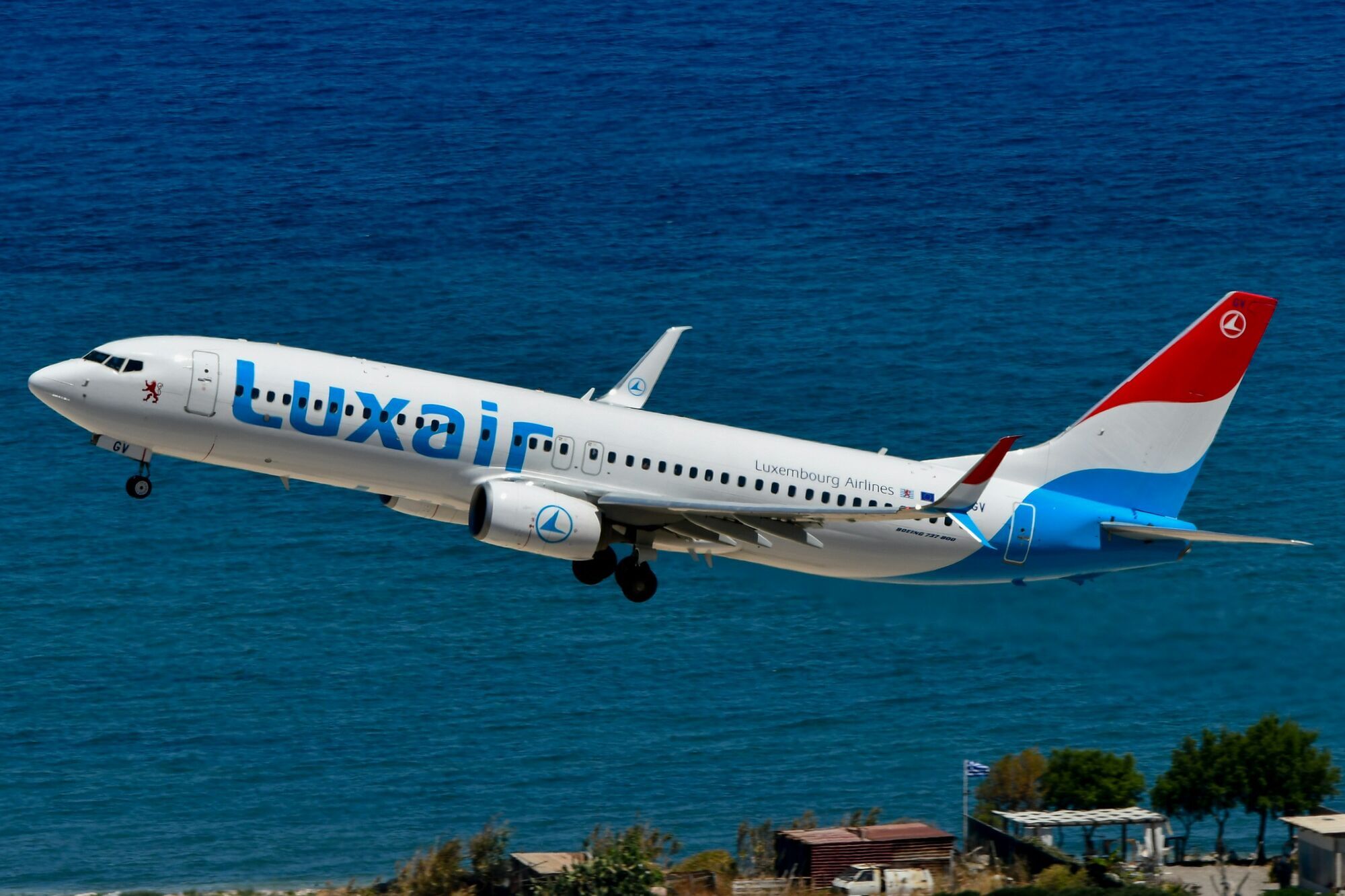 Luxair aircraft flying over the coast