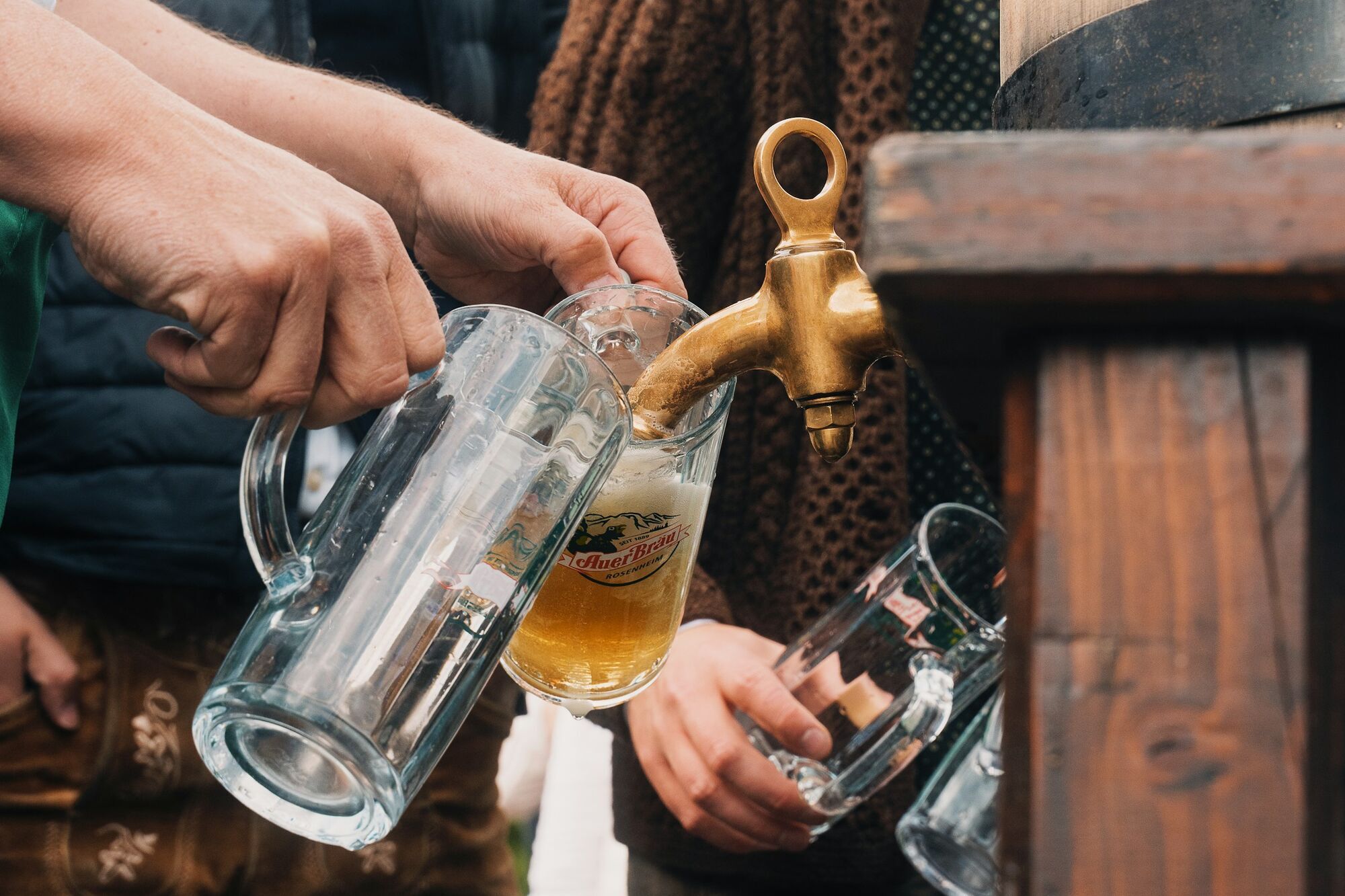 Beer being poured into glass steins