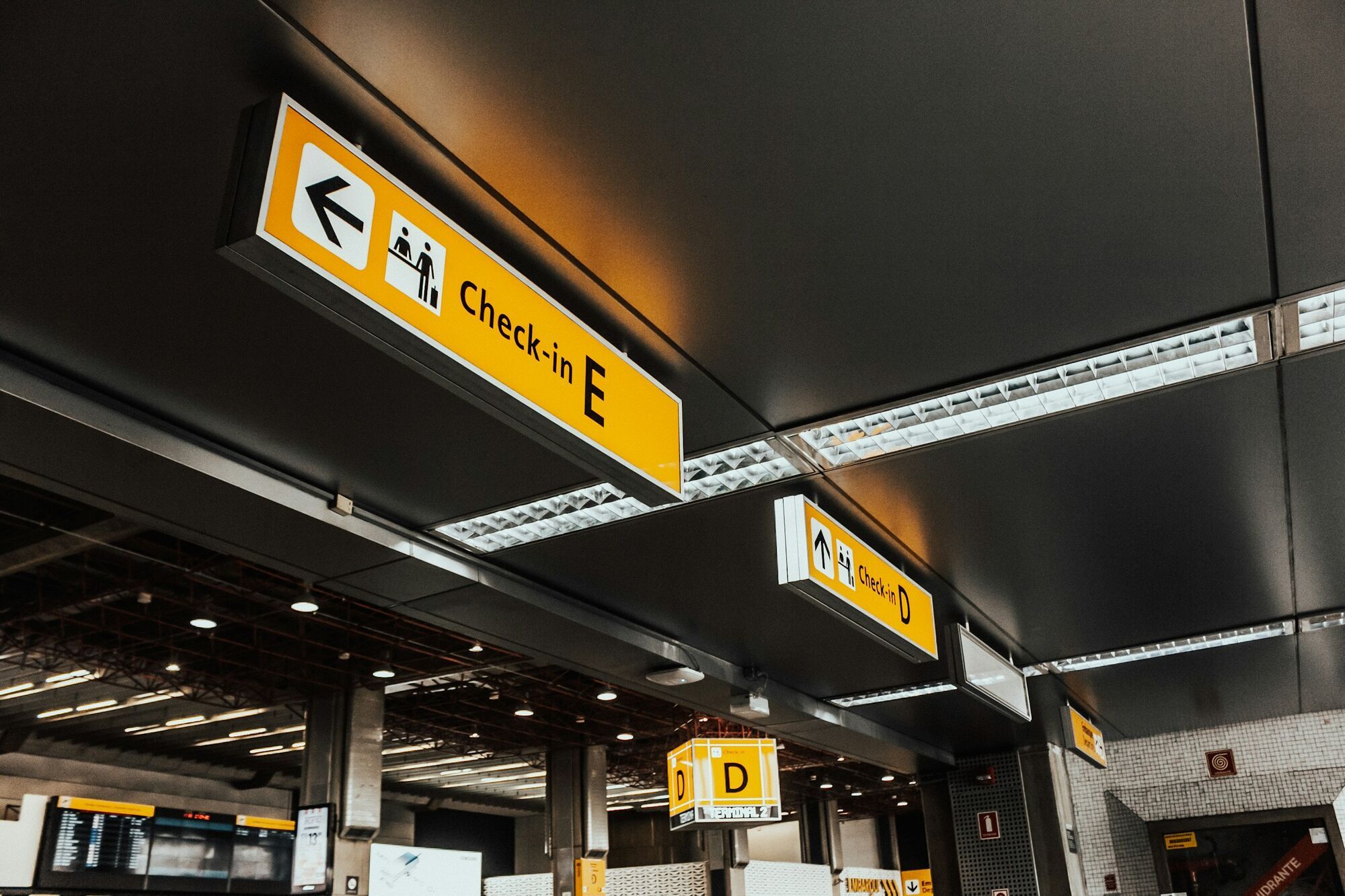 Airport check-in signs inside a terminal