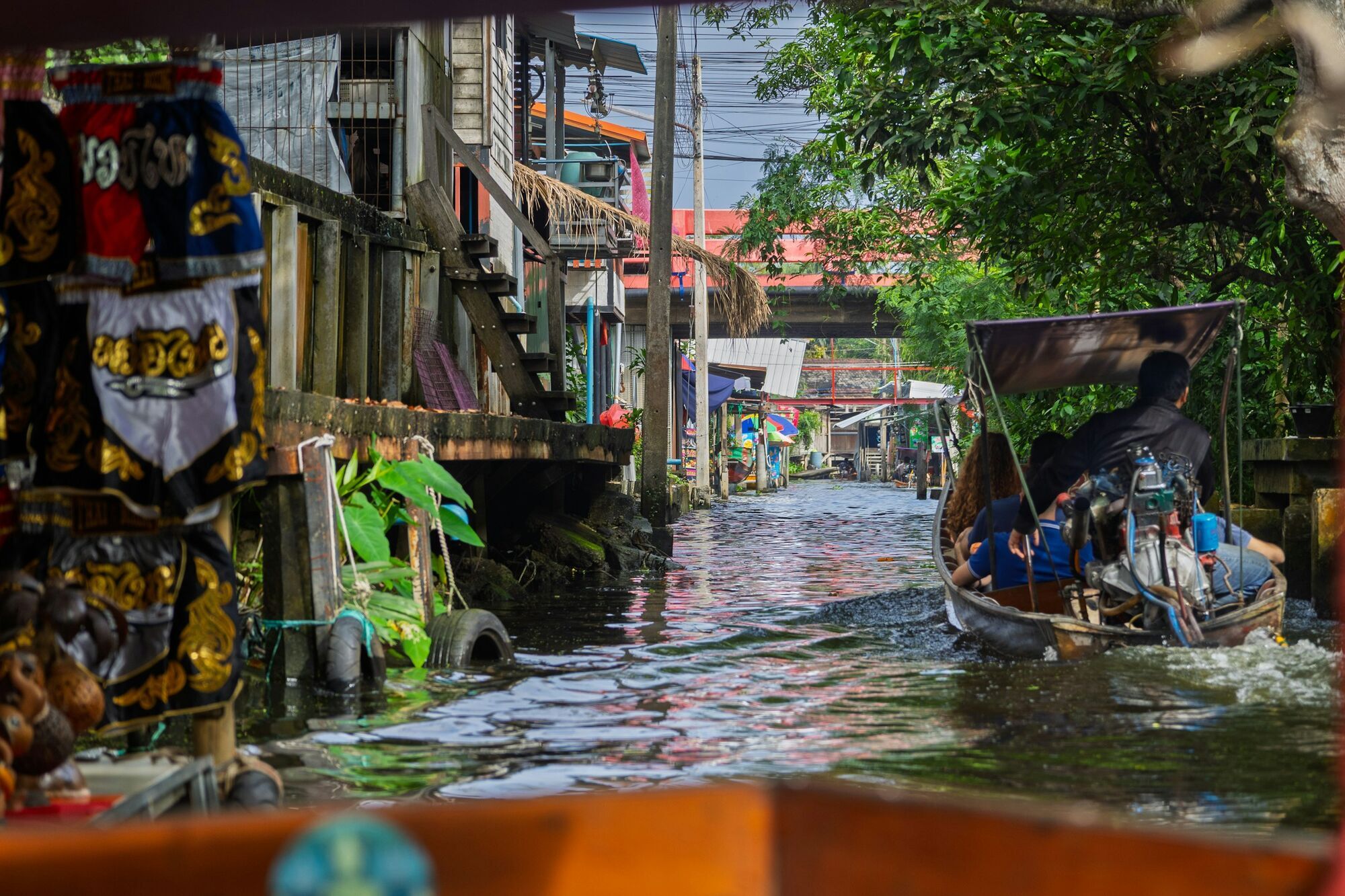 Boat travelling through a flooded Bangkok canal