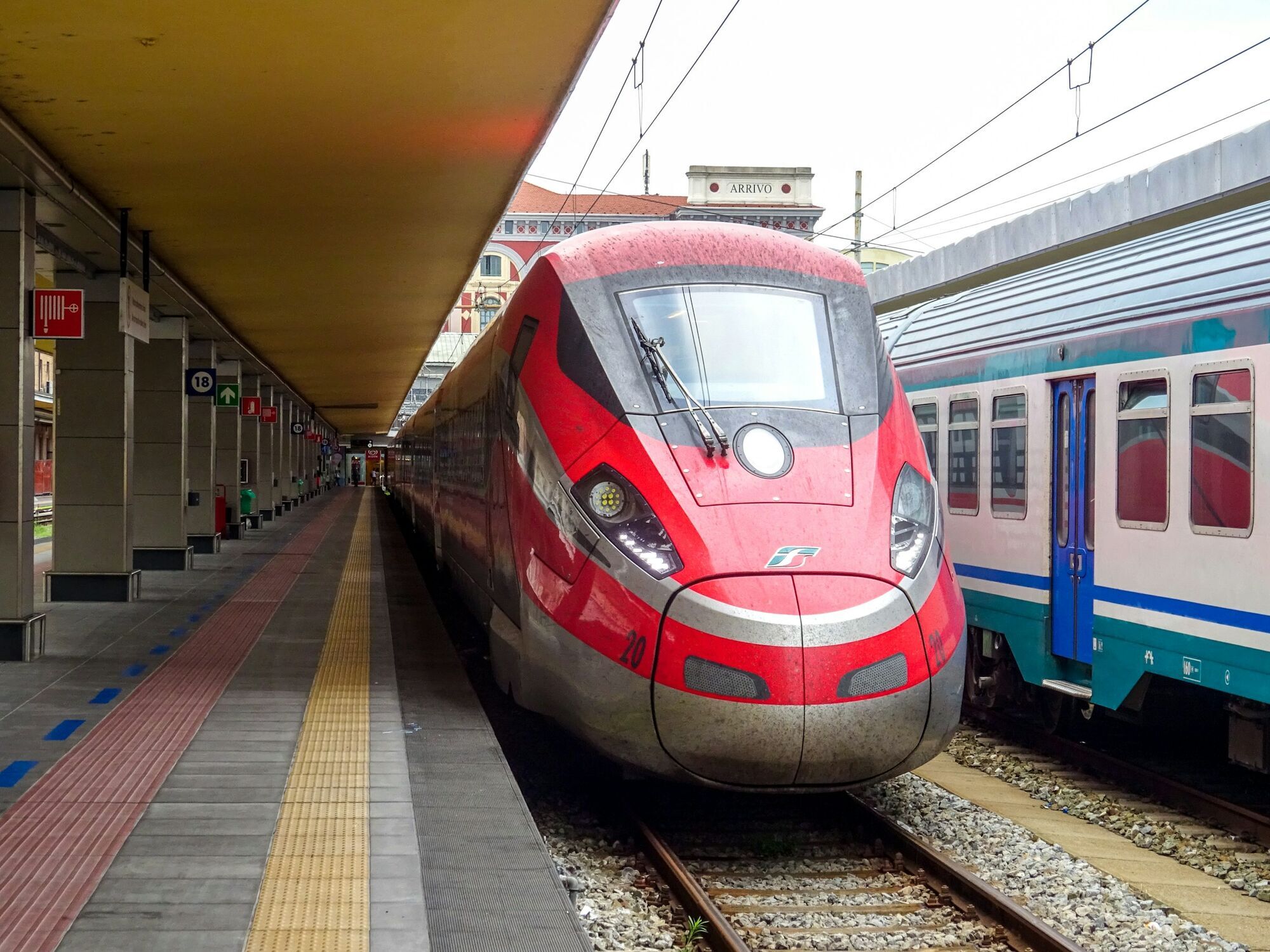 Frecciarossa train beside an Italian platform