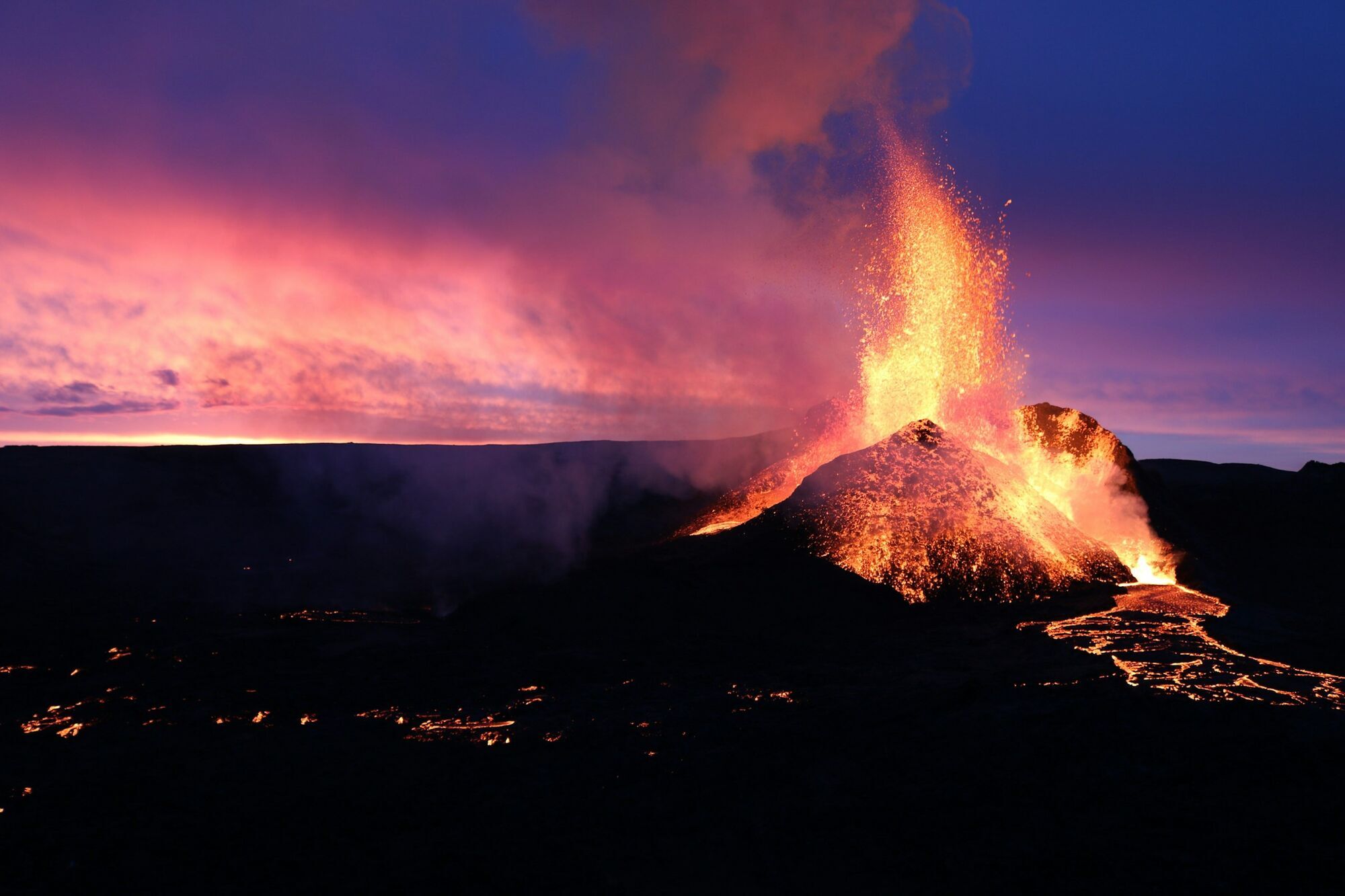 Volcano erupting with lava and ash