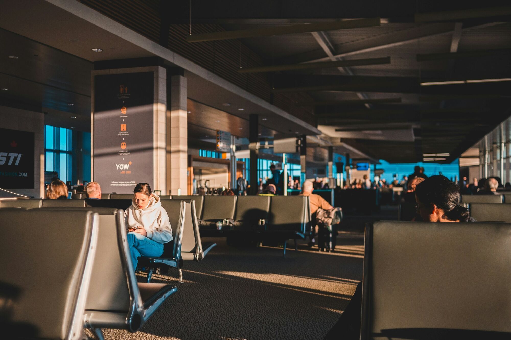 Passengers waiting inside an airport terminal