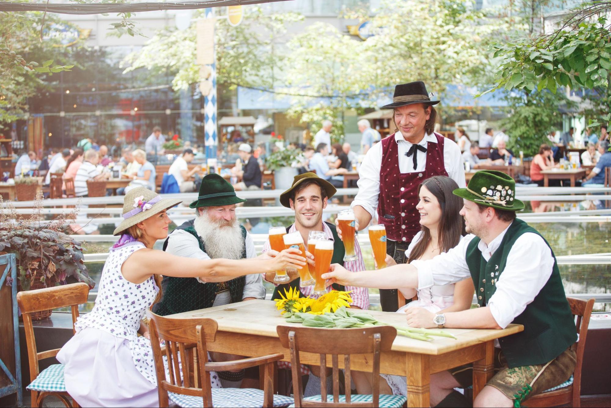 Guests in Bavarian dress at Munich Airport beer garden