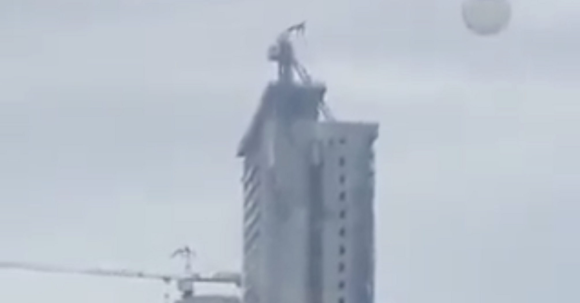 Due to an earthquake in the Philippines, a crane collapsed from the roof of a multi-story building. Video