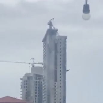Due to an earthquake in the Philippines, a crane collapsed from the roof of a multi-story building. Video