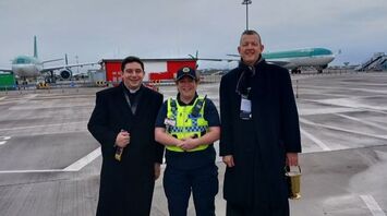 Priest blesses airplanes at Dublin airport for Christmas