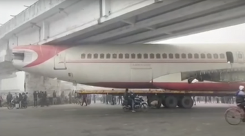 An Air India-branded plane gets stuck under a bridge, but the company has nothing to do with it. Video.