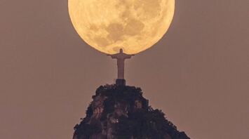 Statue of Christ The Redeemer in Rio de Janeiro holding the moon