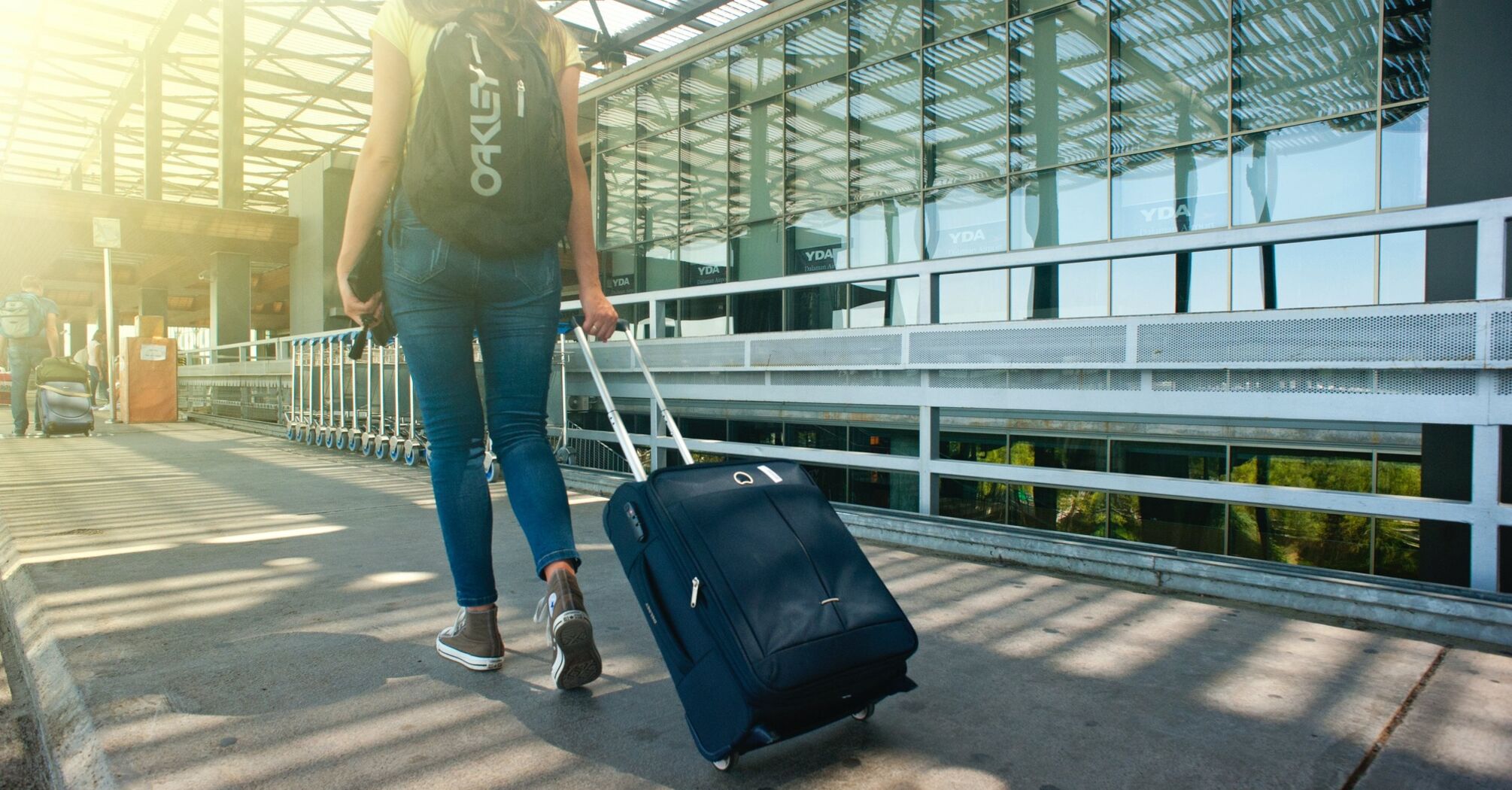 Woman walking along the path while walking with luggage