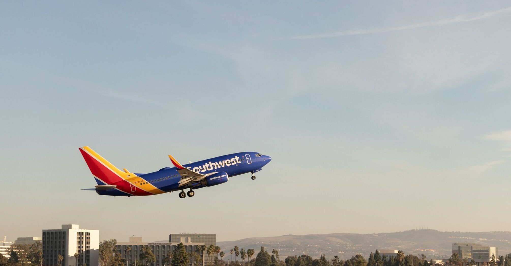 A large jetliner flying through a blue sky