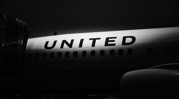 Black and white image of an airplane with the 'UNITED' logo on its fuselage