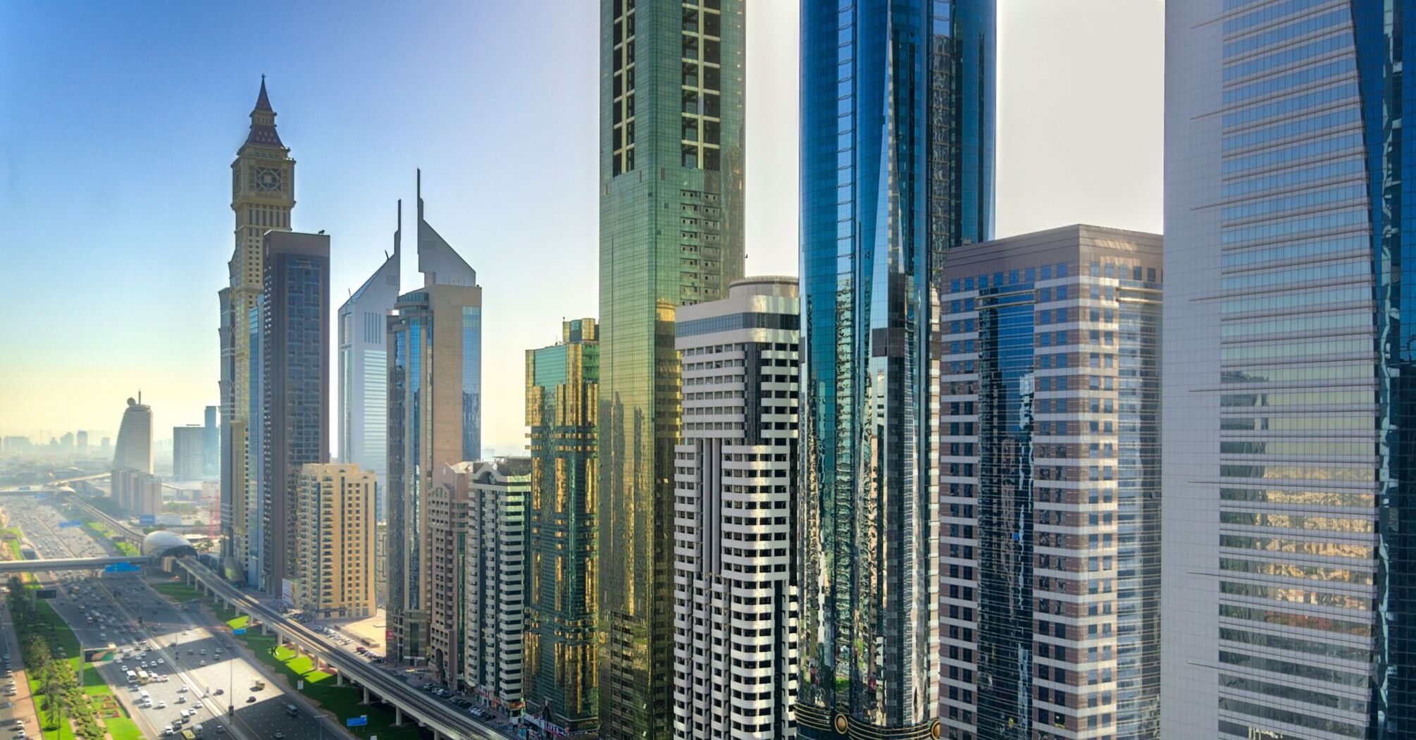 Skyline of Dubai showcasing modern skyscrapers and a bustling cityscape with a clear blue sky