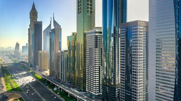 Skyline of Dubai showcasing modern skyscrapers and a bustling cityscape with a clear blue sky