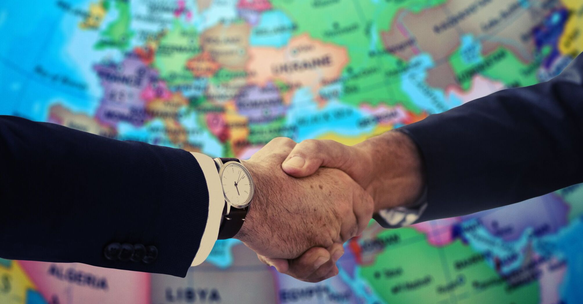 Handshakes on the background of a world map