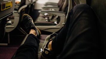 What to do if your neighbor's feet invade your space on an airplane: advice from an etiquette expert