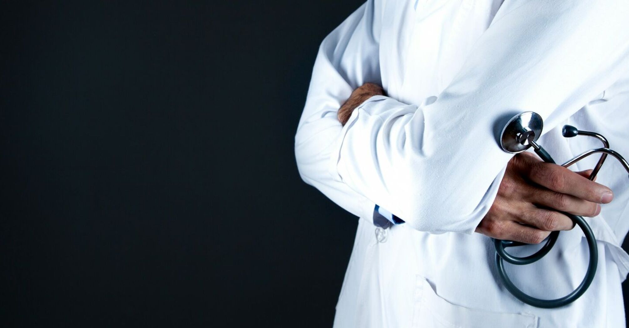 Doctor in a white coat holding a stethoscope