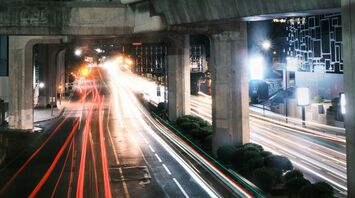 Elevated highway at night with blurred traffic lights