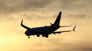 Silhouette of a Boeing 737 in flight at sunset