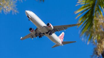 Virgin Australia airplane flying against a clear blue sky