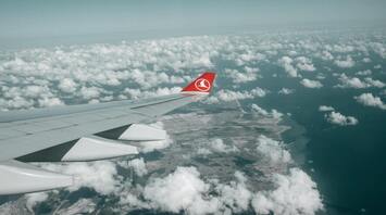 View of the ground and clouds from a Turkish Airlines flight