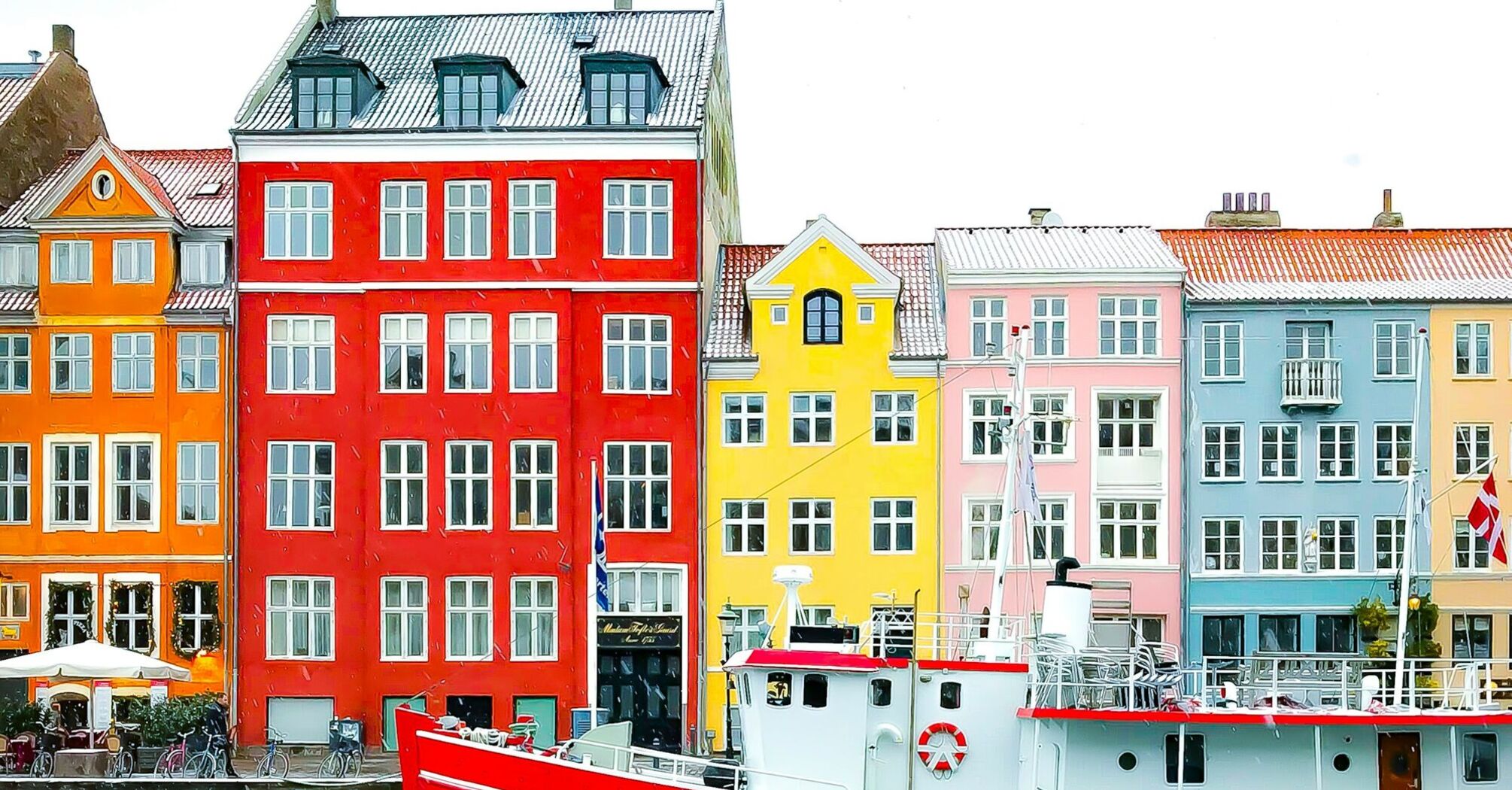 Colorful buildings and a red boat on the waterfront in Copenhagen, Denmark