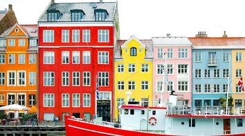 Colorful buildings and a red boat on the waterfront in Copenhagen, Denmark