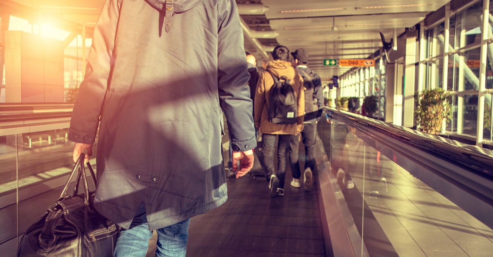 Passenger walking through an airport terminal with luggage